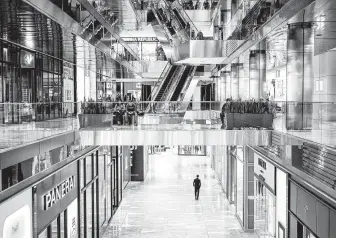  ?? Ashley Gilbertson / New York Times ?? A virtually deserted shopping area in New York on March 13. Economists say there is little doubt the nation is headed into a recession because of the coronaviru­s pandemic.