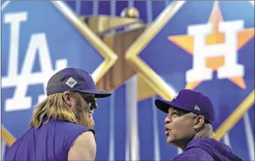  ?? CHARLIE RIEDEL / ASSOCIATED PRESS ?? Los Angeles manager Dave Roberts (right) chats with Justin Turner during a batting-practice session in Houston. The Dodgers and Astros played Friday night with the World Series tied at 1-1.