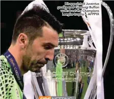  ??  ?? Disappoint­ed Juventus goalkeeper Gianluigi Buffon walks past the Champions League trophy. – AFPPIX