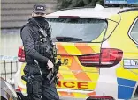  ??  ?? RAID Armed officer in Dewsbury, West Yorks