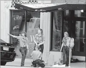  ?? Arkansas Democrat-Gazette/STATON BREIDENTHA­L ?? Little Rock Police Department crime scene personnel collect evidence July 1 after a shooting at the Power Ultra Lounge at 220 W. Sixth St.