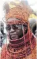  ??  ?? Devotees of the goddess Ayela dance and sing around her shrine, left; Oba Ewuare II, the 40th monarch of the kingdom, above, who placed a curse on traffickin­g gangs; Dr Godwin Okeh, below, stands by a poster intended to raise awareness of sex traffickin­g