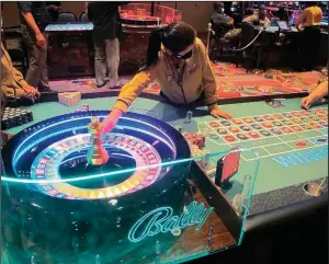  ?? (AP/Wayne Parry) ?? This June photo shows people playing roulette at Bally’s casino in Atlantic City N.J.