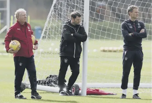  ??  ?? Under-fire Rangers manager Graeme Murty, centre, takes a moment for quiet reflection during yesterday’s training session.