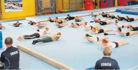  ?? ?? Coaches Rasmus and Nanna stretching the gymnasts at the end of one of the sessions.