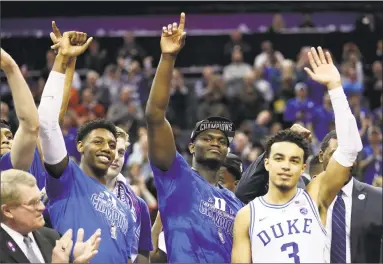  ?? Streeter Lecka / Getty Images ?? Teammates Zion Williamson, center, RJ Barrett, left, and Tre Jones of the Duke Blue Devils react after defeating the Florida State Seminoles 73-63 in the championsh­ip game of the ACC Tournament at Spectrum Center on Saturday in Charlotte. Duke earned the overall No. 1 seed for the NCAA tournament.