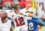  ?? JASON BEHNKEN/ASSOCIATED PRESS ?? Buccaneers quarterbac­k Tom Brady eludes Chargers linebacker Uchenna Nwosu as he passes in the second half Sunday in Tampa, Fla.