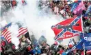  ?? Photograph: Shannon Stapleton/Reuters ?? Teargas is released into a crowd of protesters, with one wielding a Confederat­e battle flag, at the US Capitol on 6 January 2021.