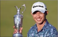  ?? (AFP) ?? Collin Morikawa poses for pictures with the Claret Jug, the trophy for the Champion Golfer of the Year, after winning the 149th British Open at Royal St George’s, Sandwich in England on Sunday.