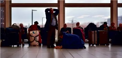  ??  ?? ABOVE: Stranded passengers wait for flights to resume on 21 December 2018. BELOW: An anti-drone device at Gatwick Airport.