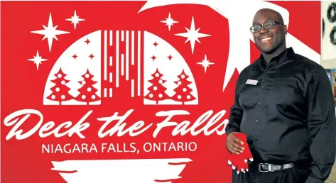  ?? ALISON LANGLEY/NIAGARA FALLS REVIEW ?? Maurice Grant, floor supervisor at Scotiabank Convention Centre, gets ready to greet visitors to the centre's photo booth during the Deck the Falls holiday tour.