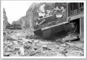  ?? ?? A knocked out Panzer VI (Tiger I) and Panzer IV sit among the ruined streets of Villers-bocage after the battle in June 1944