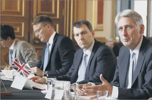  ??  ?? Chancellor of the Exchequer Philip Hammond, right, speaking to the Brazilian Finance Minister Eduardo Guardia during a meeting in London.