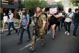  ??  ?? Armed counter-protesters left their side to march along with Black Lives Matter protesters in Provo, Utah, on 1 July. Photograph: Steven Waggoner