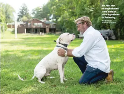  ?? PAT NABONG/ SUN-TIMES PHOTOS ?? Joe Petit with his dog Philotimo in the backyard of his Wayne home on Wednesday.