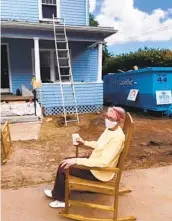  ?? JOHN KINNEY COURTESY PHOTOS ?? Gloria Scott watches the remodeling of her home from the sidewalk in mid-September.