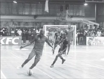  ?? ?? Clive Nobrega (left) of Bent Street attempting a pass while being pursued by Kelsey Benjamin of Sparta Boss in the GFF/Kashif and Shanghai Futsal Championsh­ip