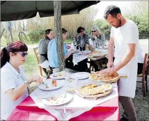  ??  ?? The results of the pizza-making class in Tuscany are enjoyed outside at communal tables set in the middle of the 500-hectare estate.