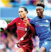  ??  ?? Liverpool’s Virgil van Dijk (left) and Chelsea’s Tammy Abraham go for the ball during the British Premier League match between Chelsea and Liverpool, at the Stamford Bridge Stadium, London, yesterday.