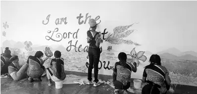  ?? ?? Youth volunteers paint a mural at the May Pen Hospital on May 17 during the Central Jamaica Seventh-day Adventists’ Operation Save a Youth initiative.