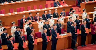  ?? by Yan Yan/ Xinhua ?? December 18, 2018: Chinese President Xi Jinping and other Chinese leaders applaud reform pioneers during the grand gathering to celebrate the 40th anniversar­y of the country’s reform and opening up.