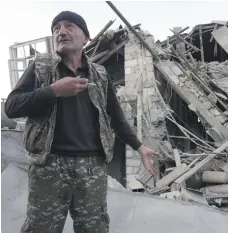  ?? AP ?? A man stands near what is left of a house that was hit by shelling in Stepanaker­t, the capital of Nagorno-Karabakh