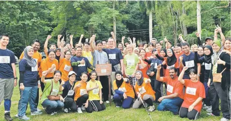  ??  ?? GOING GREEN: The Nestlé Malaysia team gathers for a memorable shot during their visit at FRIM for the recent enrichment planting activity.