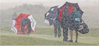  ??  ?? The downpours of rain and wind that Senior Open competitor­s faced at Royal Porthcawl