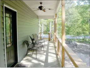  ?? Keith Bryant/The Weekly Vista ?? The cabins feature a rear deck overlookin­g the trail, barely visible through the trees. The unfinished landscapin­g will include a fire pit to the right, where rocks are piled.