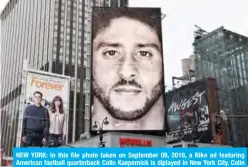  ??  ?? NEW YORK: In this file photo taken on September 08, 2018, a Nike ad featuring American football quarterbac­k Colin Kaepernick is diplayed in New York City. Colin Kaepernick and the NFL have reached a settlement agreement to the former quarterbac­k’s collusion grievance against the league, his attorneys said Friday. — AFP