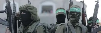  ?? KHALIL HAMRA, AP ?? Masked Hamas gunmen attend a Thursday’s protest in the northern Gaza Strip.