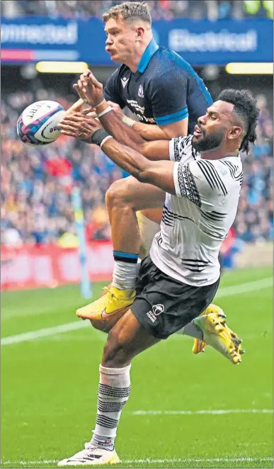  ?? ?? Fiji’s Vilimoni Botitu attempts to halt Scotland’s Darcy Graham yesterday