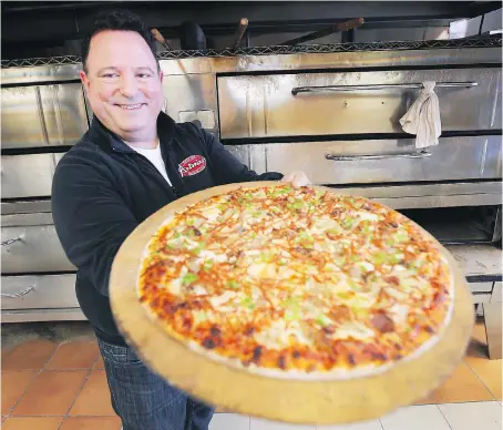  ?? PHOTOS:DAN JANISSE ?? Joe Ciaravino of Antonino’s Original Pizza Inc. says canned mushrooms are superior because they make the crust less soggy.