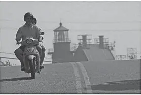  ?? THE PROVIDENCE JOURNAL FILE ?? Two people ride a motorized scooter on Block Island.