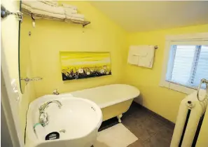  ??  ?? A vintage claw foot tub in the upstairs bathroom is a nod to the home’s deep history.