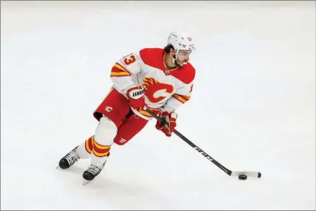  ?? The Associated Press ?? Calgary Flames left-wing Johnny Gaudreau looks to pass against the Chicago Blackhawks during the first period of an NHL game, April 18, in Chicago.