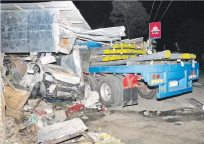  ?? (Manny Llanes) ?? A 14-WHEEL trailer truck slams into a dormitory house and a bakery after hitting 19 vehicles caught in traffic in Sta. Rosa, Manila.