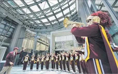  ?? Photograph­s by Mel Melcon Los Angeles Times ?? THE USC marching band performs at the Wilshire Grand Center. The project received significan­t financial assistance from the city.