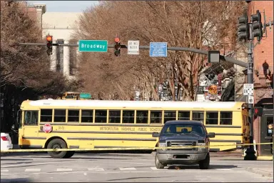  ?? (AP/Mark Humphrey) ?? A parked school bus blocks the view Monday of the damage caused in a Christmas Day explosion in downtown Nashville, Tenn.