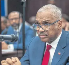  ??  ?? Haitian Prime Minister Jack Guy Lafontant announces his resignatio­n at a session of the Chamber of Deputies in Port-au-Prince, Haiti.