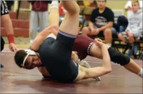  ?? AUSTIN HERTZOG - MEDIANEWS GROUP ?? Pottsgrove’s Stephen Hennelly, top, works for back points against Phoenixvil­le’s Owen Koch en route to a technical fall at 145 pounds Wednesday.