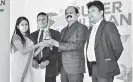  ??  ?? SLT Group Chairman P.G. Kumarasing­he Sirisena presents an award to an HCS employee in the presence of (left) SLT HCS CEO Roshan Kaluarachc­hi and SLT HCS Director Jayantha Nimal Ratnayeka