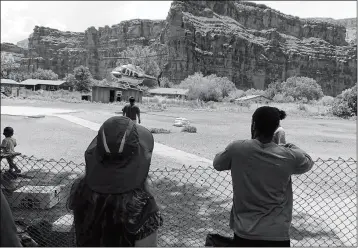  ?? BENJI XIE VIA AP ?? THIS THURSDAY PHOTO RELEASED BY BENJI XIE SHOWS A HELICOPTER LANDING to rescue people from flooding on the Havasupai reservatio­n in Supai, Ariz. Rescue workers evacuating about 200 tourists Thursday who were caught in flash flooding at a popular campground on tribal land near the Grand Canyon where visitors go to see towering blue-green waterfalls.