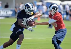  ??  ?? Rams running back Todd Gurley takes a handoff from quarterbac­k Jared Goff during training camp July 27 in Irvine, Calif. KIRBY LEE/USA TODAY SPORTS