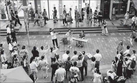  ?? PHOTOS PROVIDED TO CHINA DAILY ?? Performanc­e by South Korean band Harmonica attracts a crowd.