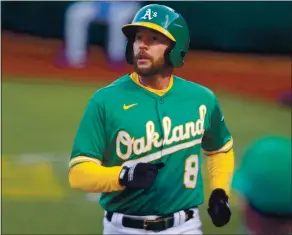  ?? RAY CHAVEZ — STAFF PHOTOGRAPH­ER ?? Jed Lowrie of the A’s heads to the dugout Tuesday after he scored on a double by Ramon Laureano.