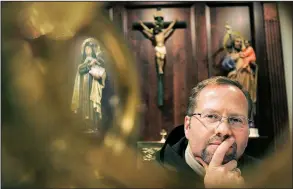  ?? AP file photo ?? Dennis Wyrzykowsk­i of Carmel Laboratori­es LLC poses in a chapel at a Carmelite monastery in Millbury, Mass., in 2009. Wyrzykowsk­i has sued L’Oreal, accusing the company of stealing patented technology in a wrinkle cream.