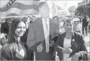  ??  ?? A SELFIE MOMENT: Crystal Siri and her mother, Maria Siri of Laos, pose with a Donald Trump figure.