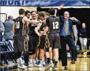  ?? NICK GRAHAM/STAFF ?? The Alter Knights react after beating Badin 60-51 in a Division II sectional final Tuesday night at Fairmont’s Trent Arena.