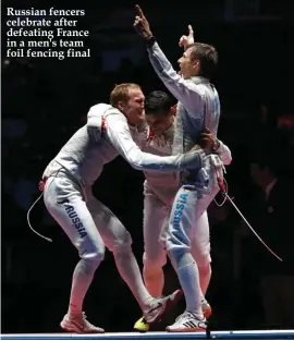  ??  ?? Russian fencers celebrate after defeating France in a men's team foil fencing final